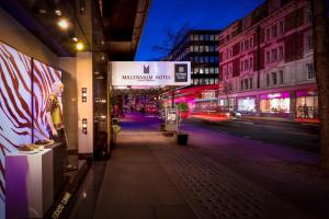 a city street at night with a sign for a mhmuseum your at Millennium Hotel London Knightsbridge in London