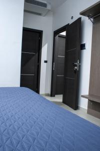 a bedroom with two black doors and a bed at Hotel Cristian in Giugliano in Campania