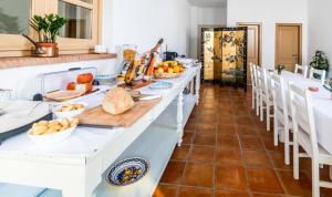 a long table with plates of food on it at Abetarda CC in São Marcos da Ataboeira