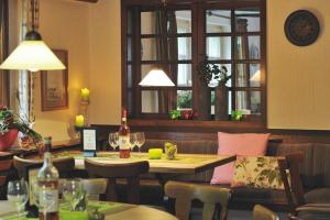 a restaurant with a table and chairs and a window at Forellenhof Poggel in Eslohe