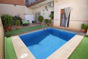 a swimming pool in the backyard of a house at Casa Rural Alonso Quijano in Argamasilla de Alba