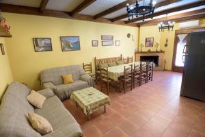 sala de estar con sofá y comedor en Casa Rural Alonso Quijano en Argamasilla de Alba