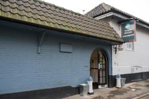 a blue building with a sign in front of it at The Town House by Innkeeper's Collection in Norwich