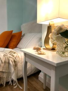 a bedroom with a bed and a table with a lamp at Modern Boutique Studio Apartment in Bournemouth