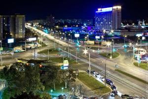 a city lit up at night with street lights at Studiominsk 8 Apartments in Minsk