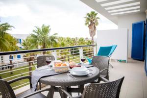 a table with a basket of fruit on a balcony at B06 - Top-Floor Marina 2 bed Apartment in Lagos
