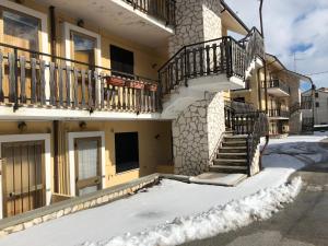 a building with snow in front of it at Appartamento in residence Ovindoli in Ovindoli