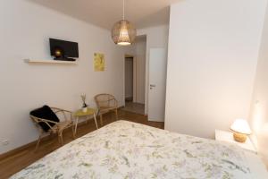 a bedroom with a bed and a table and chairs at Le Domaine des Prés in Lachambre