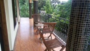 a balcony with two wooden benches on a balcony at Bright Star Hotel in Arusha