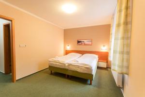 Posteľ alebo postele v izbe v ubytovaní Hotel Na Kocandě