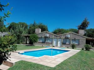 a house with a swimming pool in the yard at Cabañas La Rosita in San Agustín de Valle Fértil