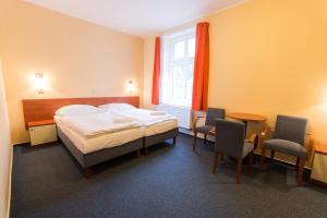 Posteľ alebo postele v izbe v ubytovaní Hotel Na Kocandě