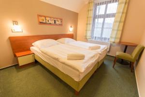Posteľ alebo postele v izbe v ubytovaní Hotel Na Kocandě