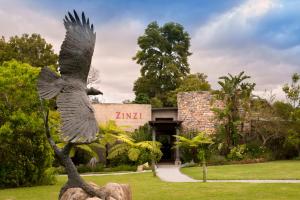a statue of an eagle in front of a building at Tsala Treetop Lodge in Plettenberg Bay