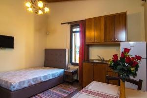 a small room with a bed and a refrigerator at Villa Morfeas - Traditional Cretan Escape with BBQ in Dhamavólos
