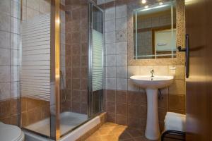 a bathroom with a shower and a sink and a sink at Villa Morfeas - Traditional Cretan Escape with BBQ in Dhamavólos +18 photos