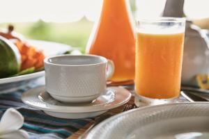 a glass of orange juice next to a cup of coffee at The Palms Zanzibar in Bwejuu