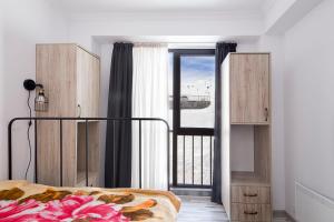 a bedroom with a bed and a large window at Apartment N320 Gudauri Loft in Gudauri +22 photos