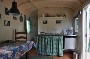 a kitchen with a table and a sink in a room at Your nice waggon at the Cow's Paradise in Amsterdam