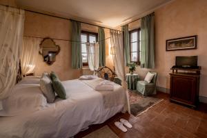 Postel nebo postele na pokoji v ubytování Agriturismo Podere La Rocca