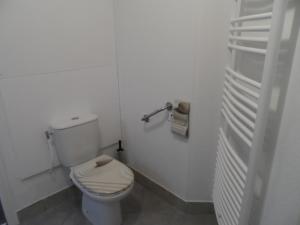 a white bathroom with a toilet and a towel rack at " B18 " T2-5p de standing au pied des pistes de Superdévoluy - "résidence Les Toits du Dévoluy" - Vue Magnifique - classé PMR in Le Dévoluy