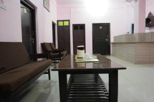 a table in a room with a bench and chairs at Hotel The Village Heart in Sawāi Mādhopur
