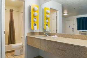 a bathroom with a sink and a toilet and a mirror at Motel 6-Bay Saint Louis, MS in Bay Saint Louis +49 photos