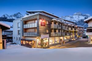 a hotel in the mountains with snow on the ground at AlpenParks Hotel Maria Alm in Maria Alm am Steinernen Meer