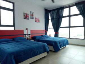 a bedroom with two beds and large windows at Eye of London @ Central Malacca in Malacca