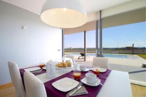 a dining room with a table and chairs and a large window at Sa Pobla 185385 in Sa Pobla