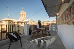 a patio with chairs and a table on a balcony at Cosy Rooms Tapinería in Valencia