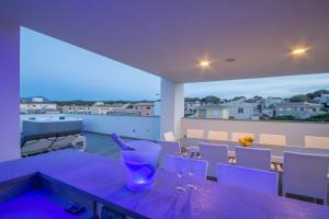 a purple table with wine glasses on a balcony at Son Serra de Marina - 1930-45 Mallorca in Son Serra de Marina