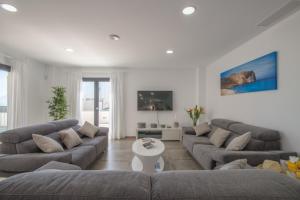 a living room with two couches and a table at Son Serra de Marina - 1930-45 Mallorca in Son Serra de Marina