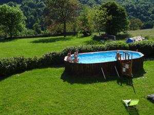 a group of people in a pool in a yard at Goute la vie in Marchamp