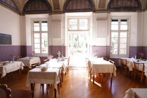 a dining room with tables with white tablecloths at Hotel Villa Bonera in Genoa