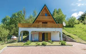 a small house with a roof on top of it at House with Pool and Sauna in Crni Lug