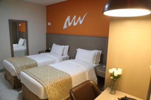 Cama ou camas em um quarto em Real Classic Bahia Hotel