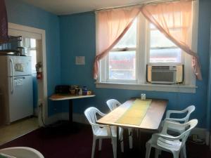 a kitchen with a table and chairs and a window at Washington Capitol Hostel in Washington, D.C.