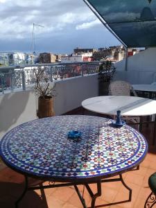 a mosaic table on top of a balcony at dar wassim el ghali in Rabat