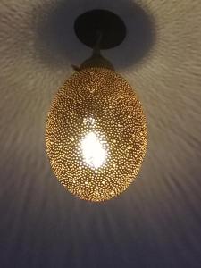 a light hanging from a ceiling at dar wassim el ghali in Rabat