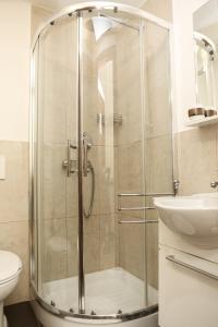 a bathroom with a shower and a toilet and a sink at Conte House merulana guesthouse in Rome