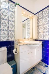 a bathroom with a sink and a toilet and a mirror at Villa Los Remos in Corralejo +18 photos