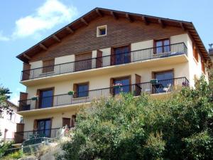 a building with a balcony on top of it at Chalet Les Lupins T2 in Font-Romeu