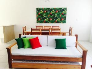 a bench with colorful pillows on it in a room at Resid. Mar da Galileia - Tonziro in Mutari