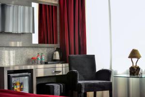 a living room with a chair and a fireplace at A11 Hotel Atasehir in Istanbul