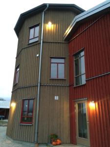 a tall building with windows on the side of it at Flyingehus Gårdshotell in Flyinge