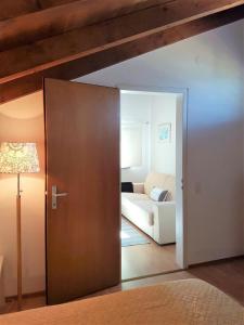 sala de estar con sofá y puerta de madera en Collinetta di Montagnola, en Montagnola