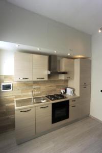 a kitchen with a sink and a stove top oven at Le Gemme 1 in Empoli