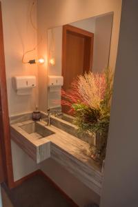 a bathroom with a sink and a mirror at Hotel Blumenhof Balneário Camboriú in Balneário Camboriú