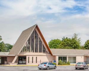 a church with two cars parked in a parking lot at Parkview Inn and Conference Center in Allentown